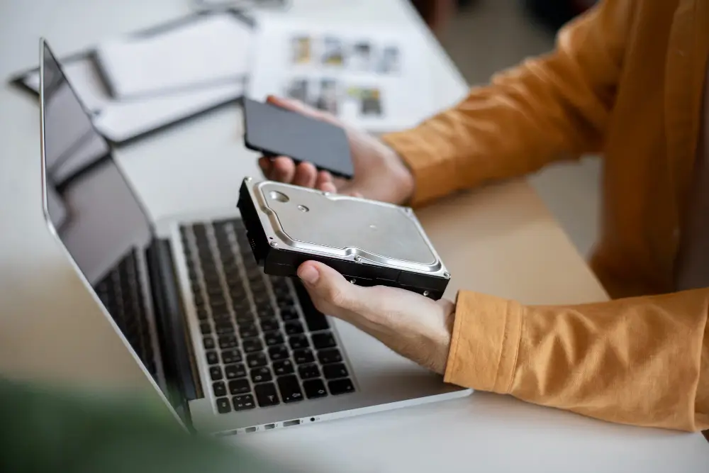 Man using used external storage device - Represents refurbished technology being put to use